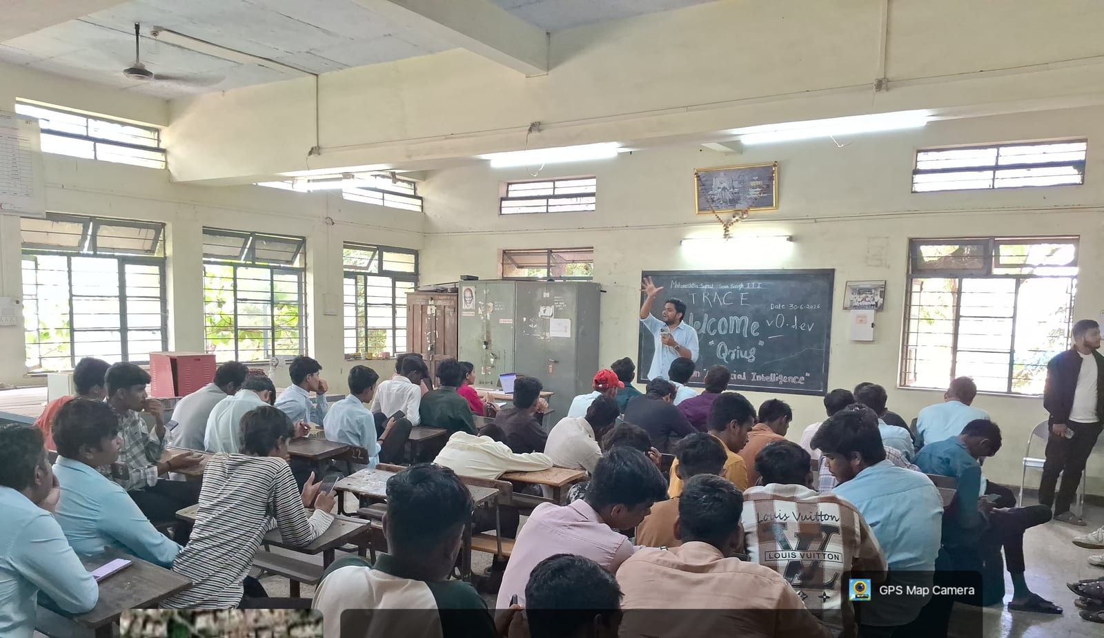 A facilitator presenting AI literacy fundamentals to a classroom of students, with a QriusAI-branded slide on screen.