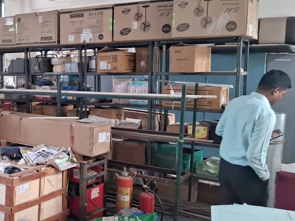 Boxed equipment stacked on metal shelves in a storeroom at a government ITI in Nashik, Maharashtra