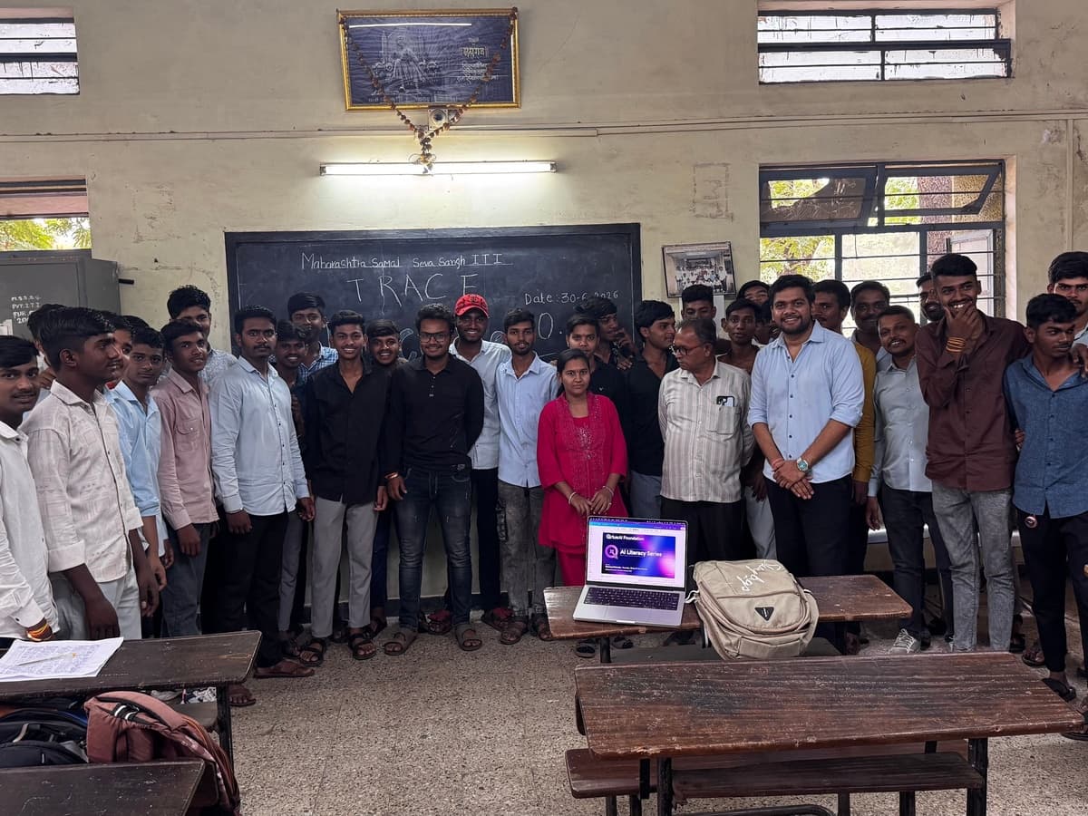 Students and a facilitator standing together in a classroom at an ITI in Nashik, with a laptop open on a desk in front